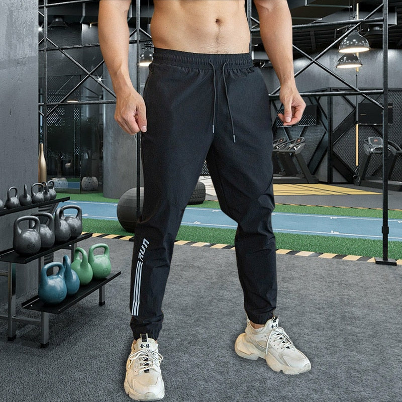 Mens Gym Fitness Running Sweatpants Workout Athletic Long Pants Outdoor Training Sports Trousers Elastic Waist Zipper Pockets