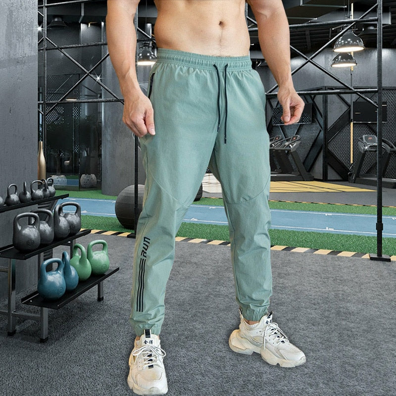 Mens Gym Fitness Running Sweatpants Workout Athletic Long Pants Outdoor Training Sports Trousers Elastic Waist Zipper Pockets