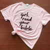 pink tee black text